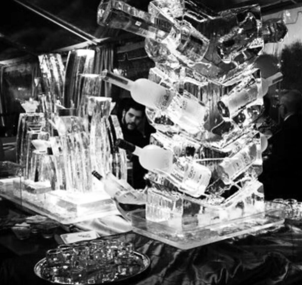 liquor bottles stored in an ice sculpture as a way to keep events cool
