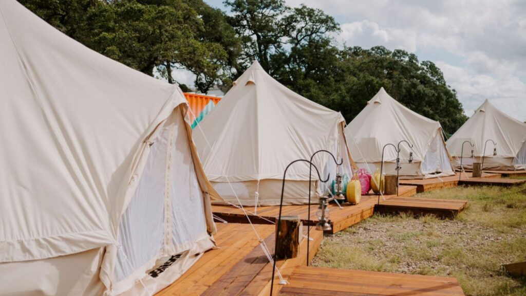 a row of tents from a luxury glamping event at Round Top