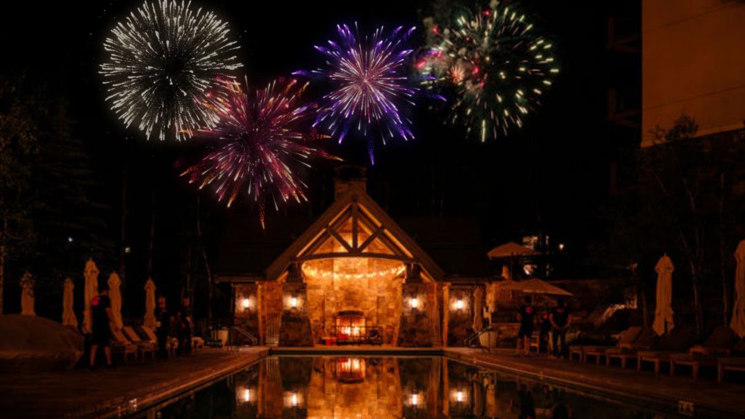 fireworks exploding over a pool at night